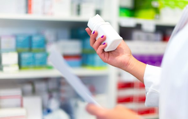 Woman customer in the pharmacy taking a medicine box Woman customer in the pharmacy taking a medicine box